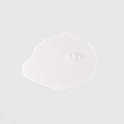 Mixi Plus Hydrating Toner thin fluid swatch with scalloped edges and single clear bubble showing weightless water-like texture