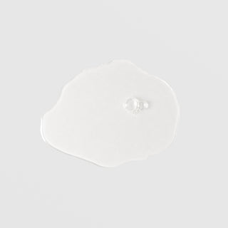Mixi Plus Toner thin fluid swatch with scalloped edges and single clear bubble showing weightless water-like texture
