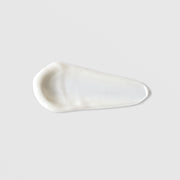Mixi SPF 50 Mineral Sunscreen texture swatch showing smooth white mineral sunscreen formula on grey background.