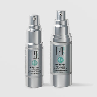 NeoGenesis Booster Advanced Renewal Serum in two sizes: 15 mL and 30 mL, shown side by side in full chrome silver airless pump bottles with teal molecular icon labels on a light gray background