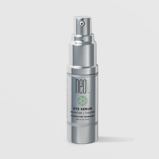 NeoGenesis Eye Serum Brighten and Tighten 15 mL in a full chrome silver airless pump bottle with green molecular icon label on a light gray background