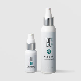 NeoGenesis Glide Gel Conductive Gel in two sizes: 30 mL and 120 mL, shown side by side in white pump bottles with chrome silver collars and teal four-petal icon labels on a light gray background
