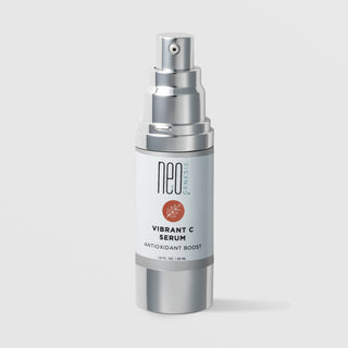 NeoGenesis Vibrant C Serum Antioxidant Boost 30 mL in a full chrome silver airless pump bottle with light gray label and terracotta botanical leaf icon on a light gray background