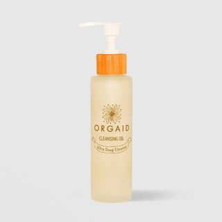 ORGAID Cleansing Oil Ultra Deep Cleanse frosted pump bottle with bamboo cap on grey background