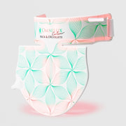 Omnilux Contour Neck & Décolleté LED device in two pieces — a curved neck band and a shield-shaped chest panel — both featuring a white and teal floral line pattern with pink LED glow along the bottom edge, displayed against a light gray background.