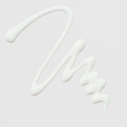 Pfect-A Solar Elixir Sunscreen SPF 50 texture swatch showing smooth white fluid formula swirled on grey background.