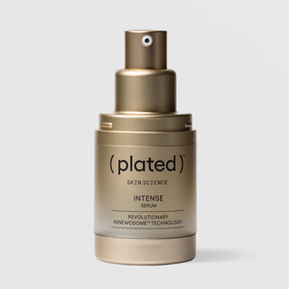 Plated Skin Science INTENSE Serum gold pump bottle with cap removed, showing airless pump dispenser design