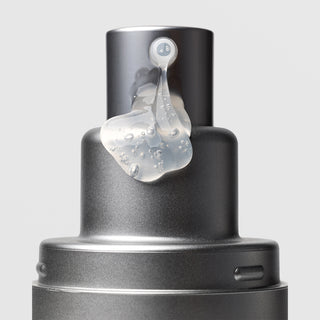 Close-up of Plated Skin Science DAILY Serum pump nozzle dispensing lightweight clear gel serum with micro-bubbles on silver metallic bottle