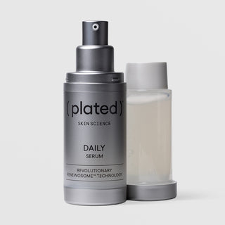 Plated Skin Science DAILY Serum silver airless pump bottle beside its refillable inner cartridge, highlighting sustainable refillable packaging