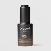 Plated Hair Science Hair Serum in matte black glass dropper bottle with cap on, featuring Renewosome technology for hair thinning and scalp health