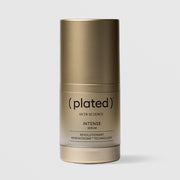 Plated Skin Science INTENSE Serum in gold cylindrical bottle with cap on, featuring Renewosome technology for skin renewal and anti-aging