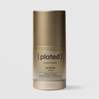Plated Skin Science INTENSE Serum in gold cylindrical bottle with cap on, featuring Renewosome technology for skin renewal and anti-aging