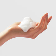 PurErb Caviar Lime Cleansing Foam rich white lather dispensed into cupped hand showing dense fluffy foam texture