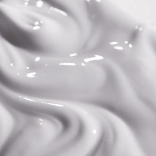 Close-up texture shot of iS Clinical Reparative Moisture Emulsion showing a rich creamy white emulsion with a smooth silky consistency