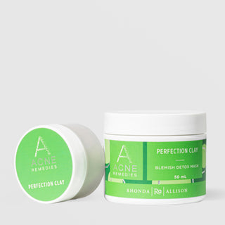 Rhonda Allison Acne Remedies Perfection Clay Blemish Detox Mask shown in both sizes: small travel jar leaning on its side and 50mL upright white jar with bright green labels on a light gray background