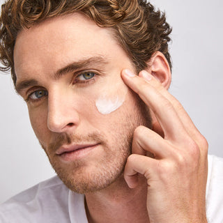 Model applying Colorescience Barrier Pro Essential Moisturizer to cheek