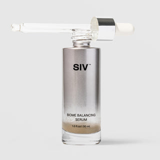 SIV Biome Balancing Serum 30mL glass bottle with dropper pipette removed and resting across the top, showing metallic silver and clear glass packaging