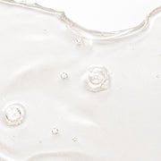Close-up texture shot of SIV Biome Balancing Serum showing a lightweight clear gel with small air bubbles on a white surface