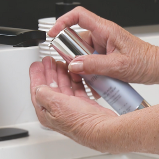 Dispensing GlyMed Plus CBD Age Delay Dew from silver pump applicator into cupped hands