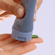 Squeezing GlyMed Plus Hydrating Masque with Enzymes green formula from light blue tube onto fingertip