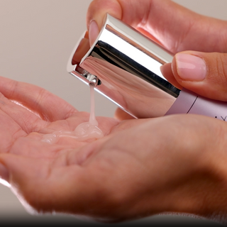 Dispensing GlyMed Plus Essential Serum with Amino Acids from silver pump applicator into cupped hand