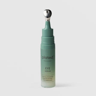 Plated Skin Science Eye Serum teal bottle with cap removed, revealing precision cooling metal roller ball applicator