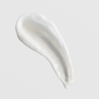 Skin Script Ageless Skin Moisturizer texture swatch showing rich glossy white anti-aging cream formula on grey background.