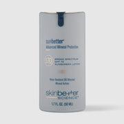 A gray bottle of Skinbetter Science sunbetter mineral sheer SPF 70 sunscreen lotion on a grey background