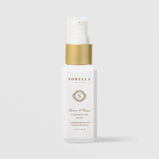 Sorella Apothecary Apricot and Mango Cleansing Milk 2 oz in a white pump bottle with gold collar on a light gray background