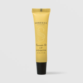Sorella Apothecary Avocado Oil Lip Hydrator 0.25 oz in a yellow tube with black cap on a light gray background