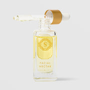Sorella Apothecary Facial Nectar 0.9 fl oz in a clear glass dropper bottle with gold label and open dropper on a light gray background