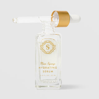 Sorella Apothecary Main Squeeze Hydrating Serum 0.9 fl oz open clear glass bottle with dropper removed showing the lightweight serum formula on a light gray background