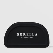 Sorella Apothecary fan mask brush with white bristles and white handle on a light gray background