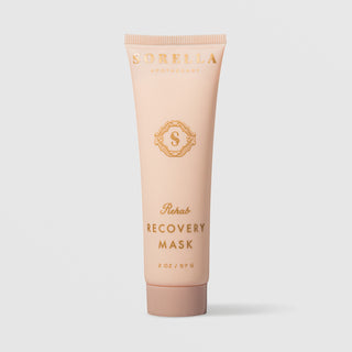 Sorella Apothecary Rehab Recovery Mask (2 oz / 57g) in a blush pink squeeze tube with gold logo and lettering, displayed upright against a light gray background