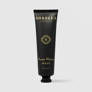 Sorella Apothecary Rosehip Warming Mask 2 oz in a matte black tube with gold label and black cap on a light gray background