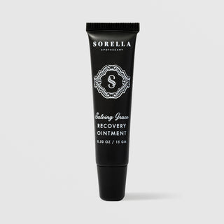 Sorella Apothecary Salving Grace Recovery Ointment 0.5 oz in a matte black squeeze tube with ornate logo on a light gray background