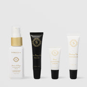 Sorella Apothecary Brightening Kit featuring four travel-size products: Apricot and Mango Cleansing Milk, Mint Poppy Seed Polish, Lemon Lightening Serum, and Blueberry Milk Moisturizer on a light gray background