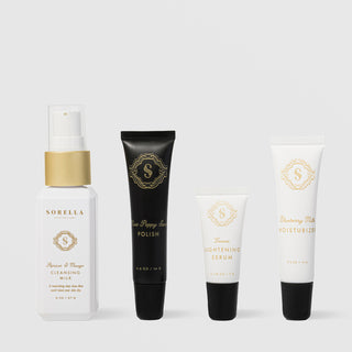Sorella Apothecary Brightening Kit featuring four travel-size products: Apricot and Mango Cleansing Milk, Mint Poppy Seed Polish, Lemon Lightening Serum, and Blueberry Milk Moisturizer on a light gray background
