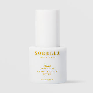Sorella Apothecary Tinted Dew Drops Broad Spectrum SPF 50 1 fl oz in a white pump bottle with cap on a light gray background