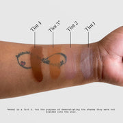 Sorella Apothecary Tinted Dew Drops SPF 50 shade range arm swatches Tints 1–4 shown on medium-deep skin tone, unblended for shade comparison