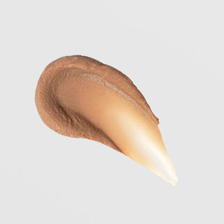 TIZO 3 Facial Primer Tinted SPF 40 texture swatch showing warm bronze-to-ivory gradient tinted mineral sunscreen on grey background