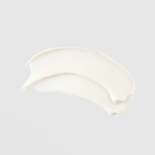 TIZO AM Replenish SPF 40 untinted sunscreen crescent-shaped cream swatch showing smooth opaque white texture on grey background