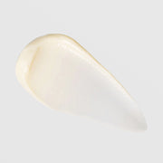 TIZO Eye Renewal SPF 20 warm ivory cream texture swatch showing rich emollient consistency with pearlescent finish on grey background