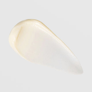 TIZO Eye Renewal SPF 20 warm ivory cream texture swatch showing rich emollient consistency with pearlescent finish on grey background