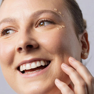 Woman applying Face Reality Antioxidant Peptide Eye Gel drops under the eye area – peptide eye treatment for dark circles and puffines