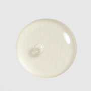 Circadia Cyto-Comm Revitalizing Serum texture swatch showing lightweight glossy gel drop with a soft ivory tone
