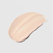 Colorescience Total Protection Body Shield Glow SPF 50 shimmery peach-toned cream texture swatch on a light gray background