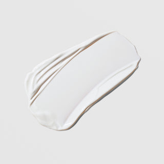 Colorescience Total Protection No-Show Mineral Body Shield SPF 50 white cream texture swatch on a light gray background