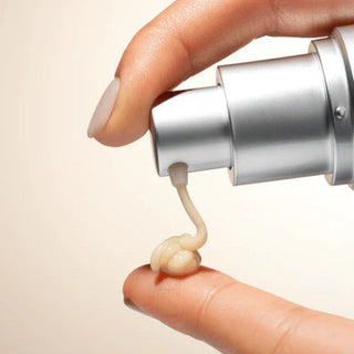 Face Reality Defense C Serum being dispensed from silver pump onto fingertip showing lightweight creamy formula - available at The Art of Skin Care