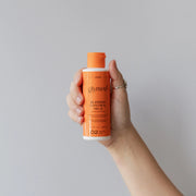 hand holding bottle with flip cap of GlyMed Plus Blemish Control No. 5 with Benzoyl Peroxide